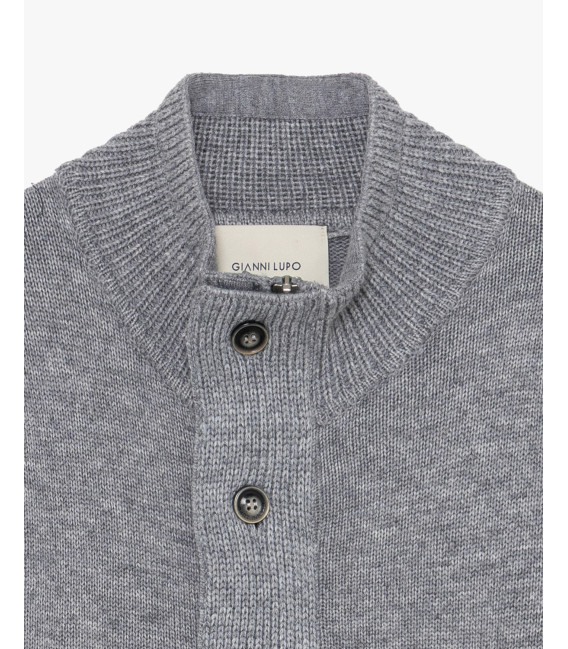 Knitted cardigan with funnel neck and button fastening.