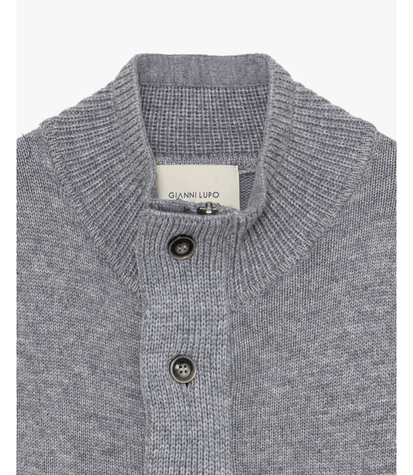 Knitted cardigan with funnel neck and button fastening.